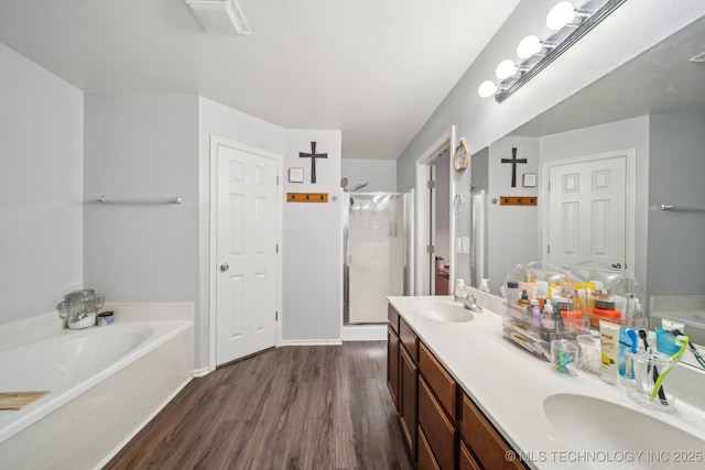 bathroom with shower with separate bathtub, hardwood / wood-style floors, and vanity