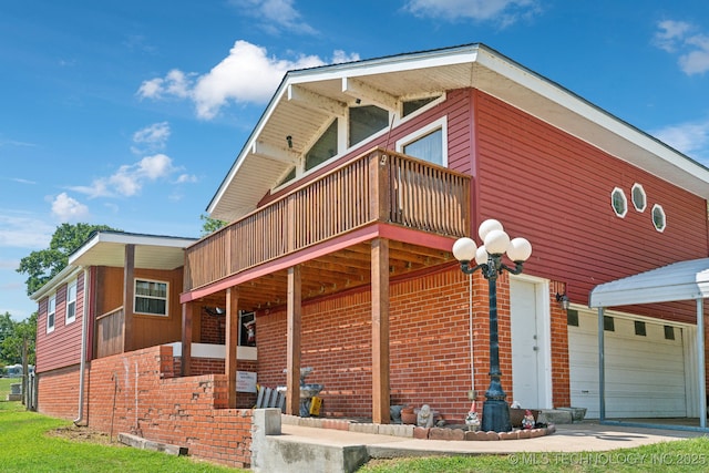 view of side of home with a balcony and a garage