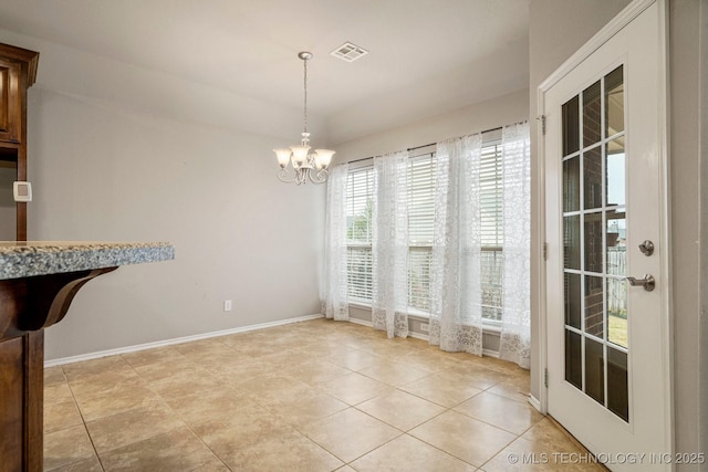 tiled dining room featuring a chandelier