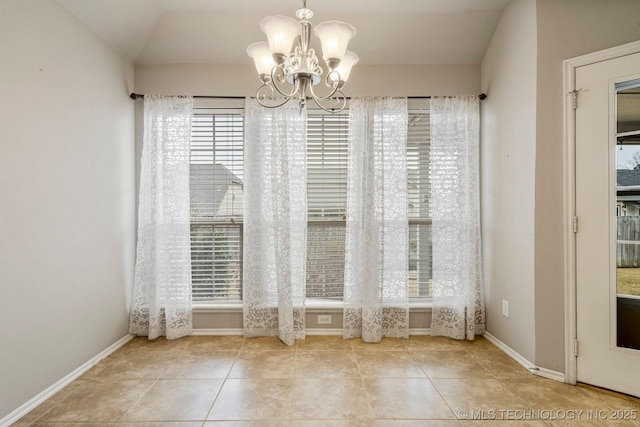 unfurnished dining area with an inviting chandelier and light tile patterned flooring