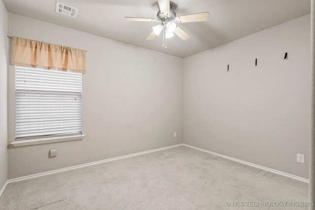 carpeted spare room with ceiling fan