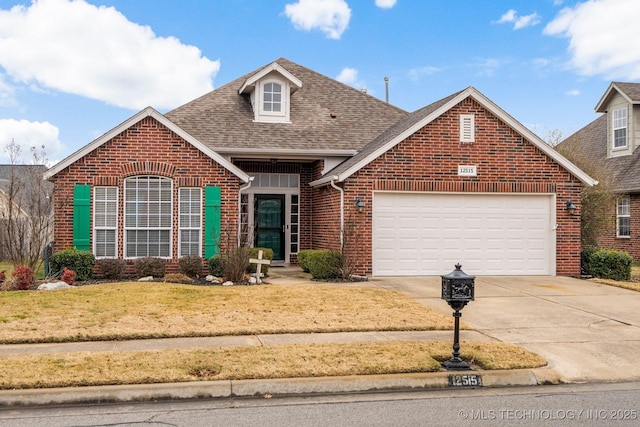 view of property featuring a garage and a front lawn