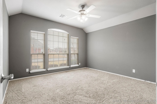 carpeted spare room with ceiling fan and vaulted ceiling