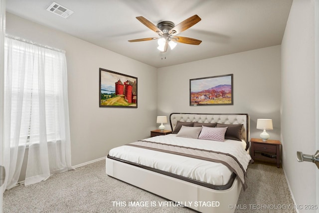 bedroom with multiple windows, light colored carpet, and ceiling fan