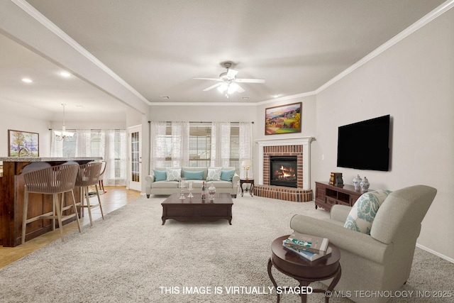 living room featuring a brick fireplace, crown molding, light tile patterned floors, and ceiling fan