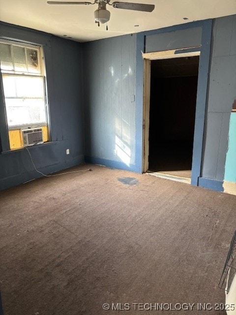 carpeted empty room featuring cooling unit and ceiling fan