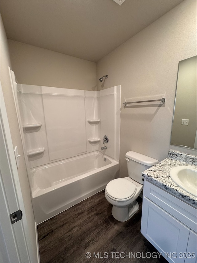 full bathroom featuring shower / bathtub combination, wood-type flooring, toilet, and vanity