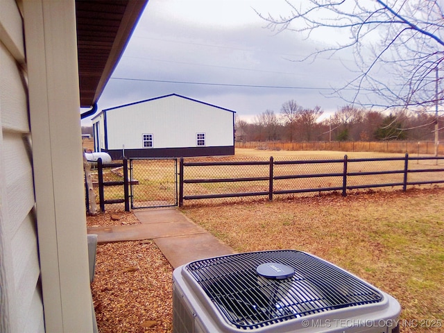 view of yard with a rural view and central air condition unit