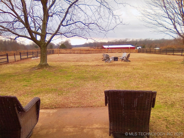 view of yard with a rural view and a fire pit