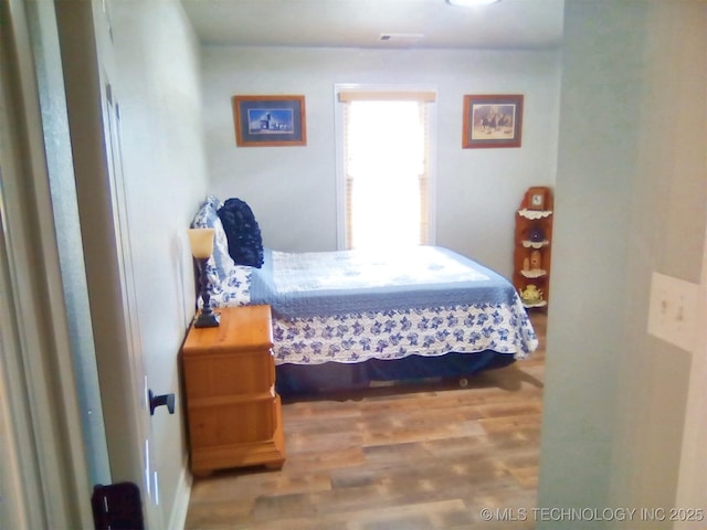 bedroom with hardwood / wood-style floors