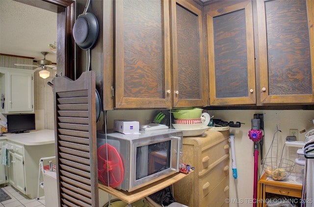 laundry room with light tile patterned floors and ceiling fan