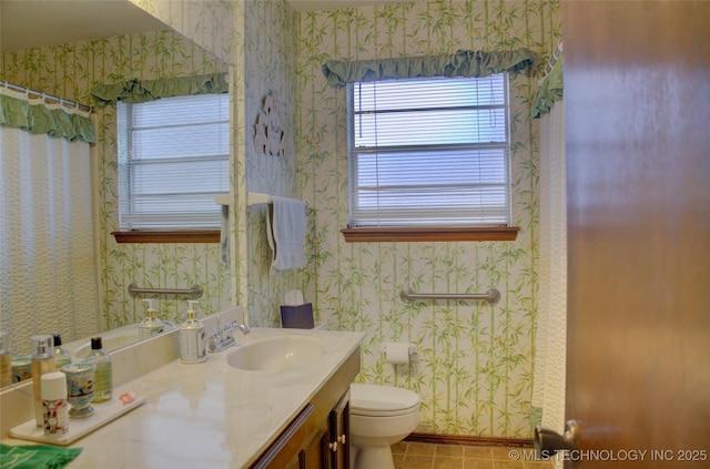 bathroom with tile patterned flooring, vanity, and toilet