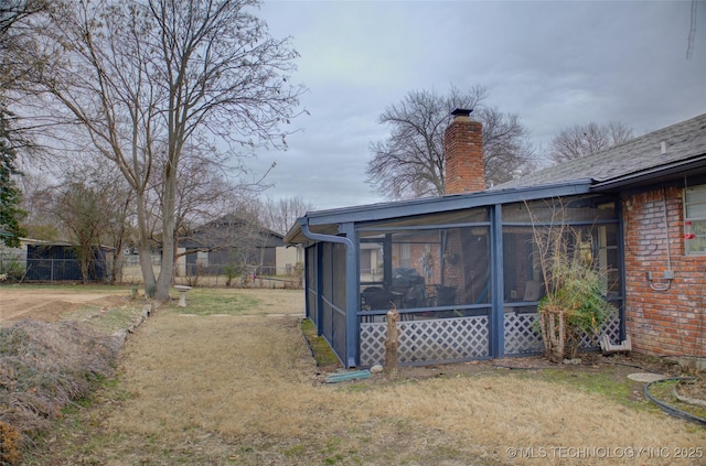 view of yard featuring a sunroom