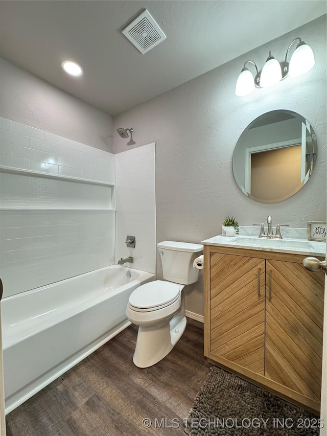 full bathroom with hardwood / wood-style flooring, vanity, toilet, and shower / bath combination