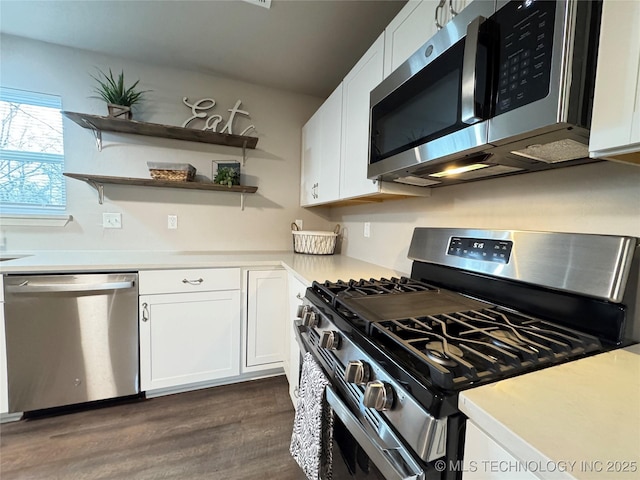 kitchen with white cabinetry, stainless steel appliances, and dark wood-type flooring