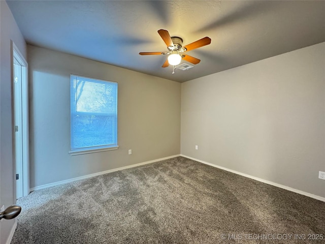 carpeted spare room featuring ceiling fan