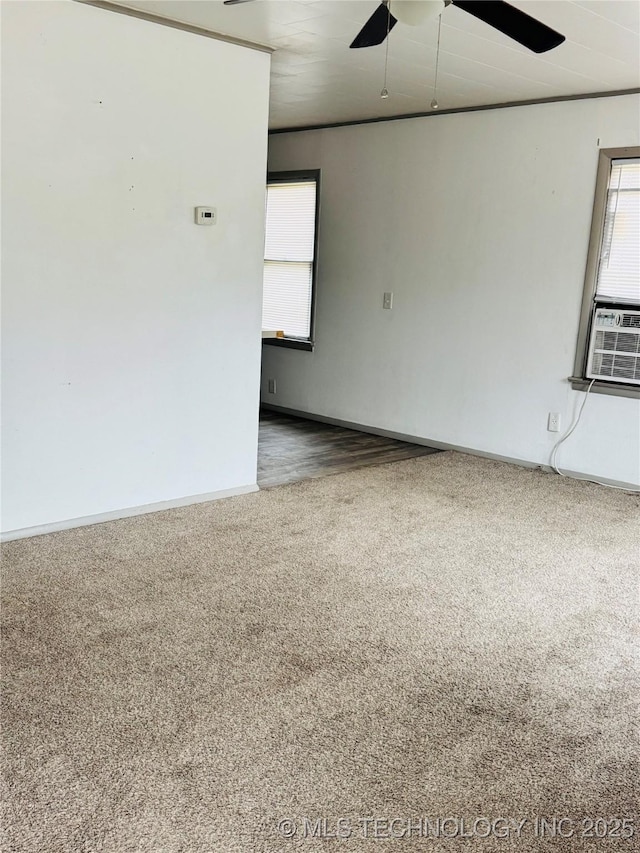 unfurnished room featuring cooling unit, ceiling fan, and carpet