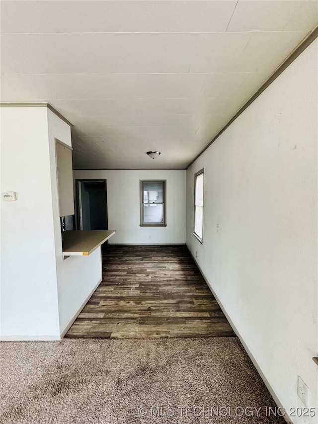 unfurnished living room with dark colored carpet