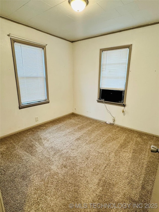 carpeted empty room featuring cooling unit and ornamental molding