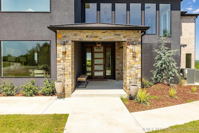 doorway to property with central AC unit