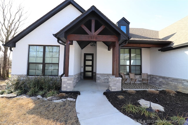 doorway to property with a porch