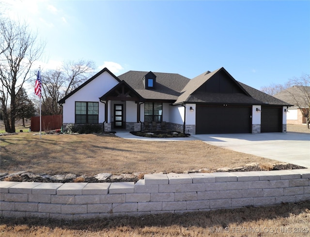 view of front of home with a garage, stone siding, concrete driveway, and a shingled roof