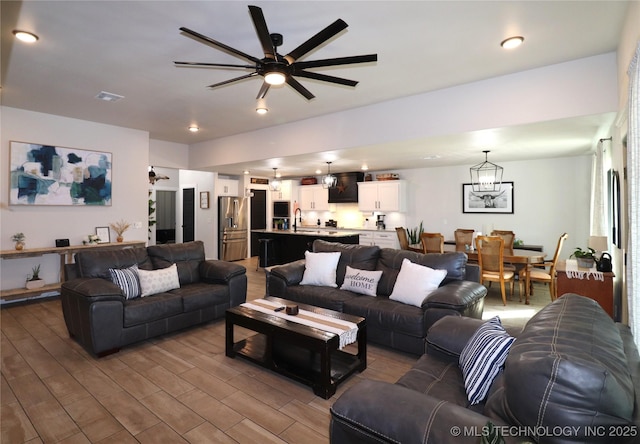 living area featuring visible vents, recessed lighting, ceiling fan, and wood finished floors