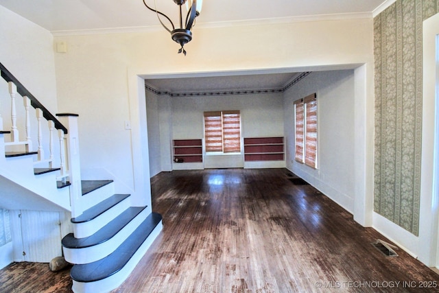 entryway with hardwood / wood-style floors and crown molding