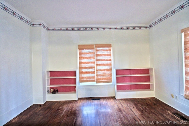 spare room featuring hardwood / wood-style flooring and plenty of natural light