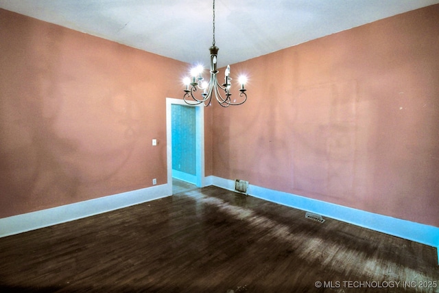 unfurnished dining area featuring hardwood / wood-style flooring and a chandelier