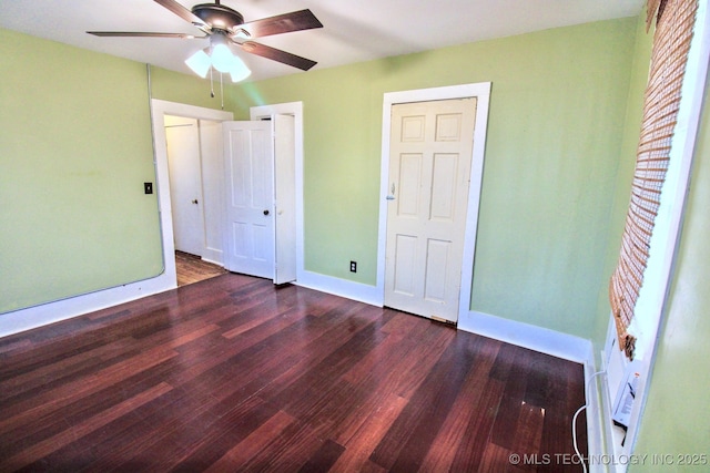 unfurnished bedroom with dark hardwood / wood-style floors and ceiling fan