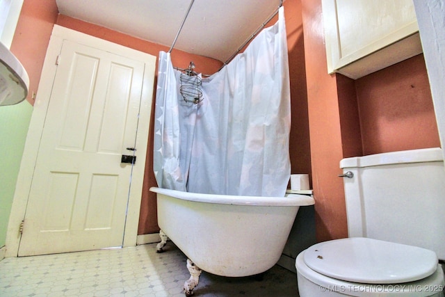 bathroom featuring toilet and a tub