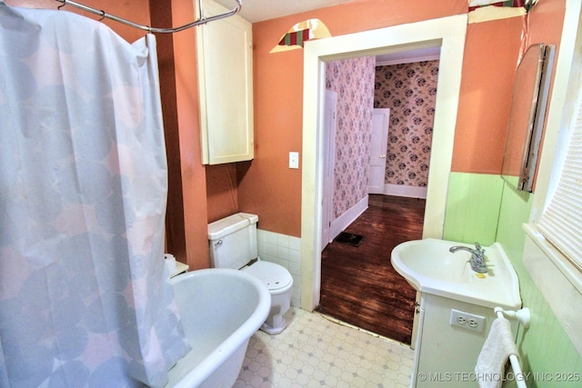 bathroom featuring vanity, curtained shower, tile walls, and toilet