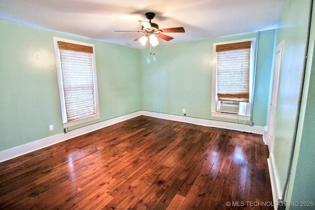 spare room with dark wood-type flooring, ceiling fan, and cooling unit