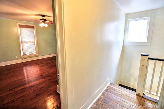 corridor with hardwood / wood-style floors