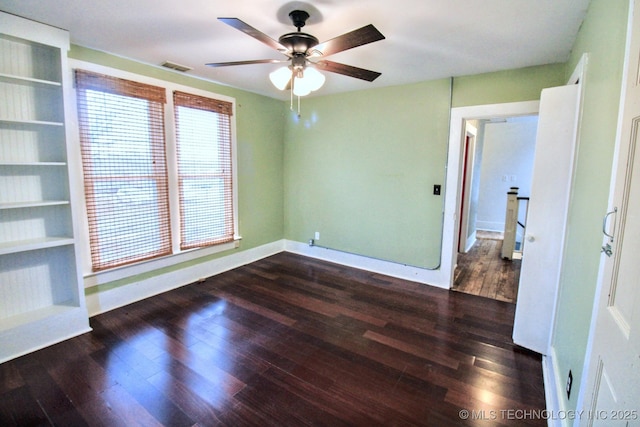 empty room with ceiling fan and dark hardwood / wood-style floors