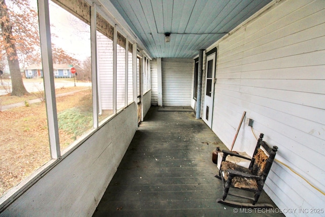 unfurnished sunroom with wooden ceiling