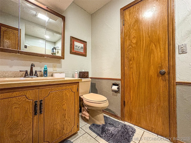 bathroom with vanity, tile patterned floors, a textured ceiling, and toilet