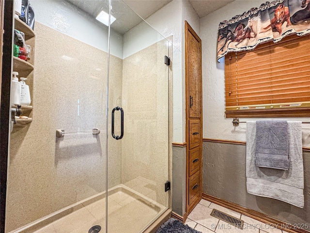 bathroom featuring tile patterned floors and walk in shower