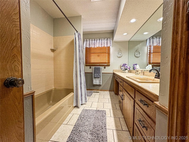 bathroom with vanity, tile patterned floors, a textured ceiling, and shower / bath combo with shower curtain