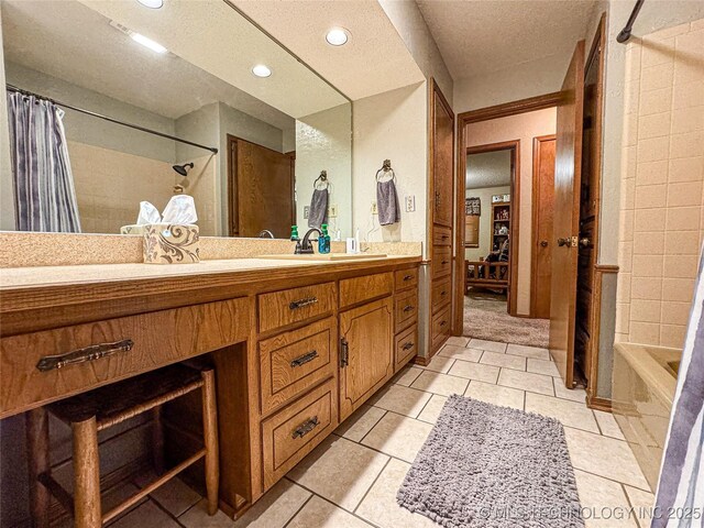 bathroom featuring vanity, tile patterned floors, and shower / bath combo with shower curtain