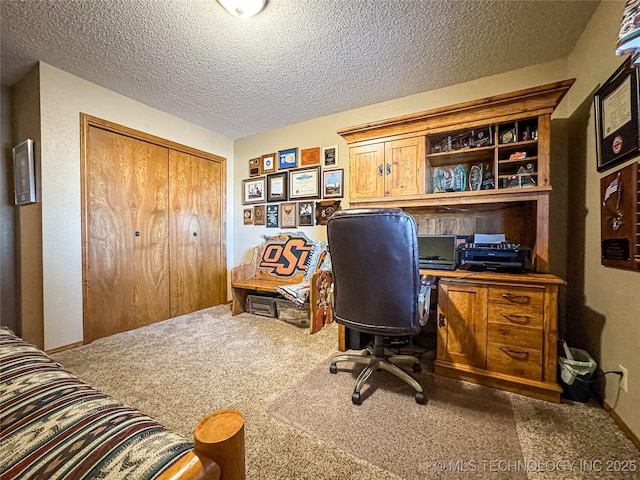 office space featuring carpet floors and a textured ceiling