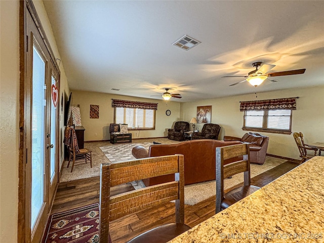 interior space with dark wood-type flooring and ceiling fan