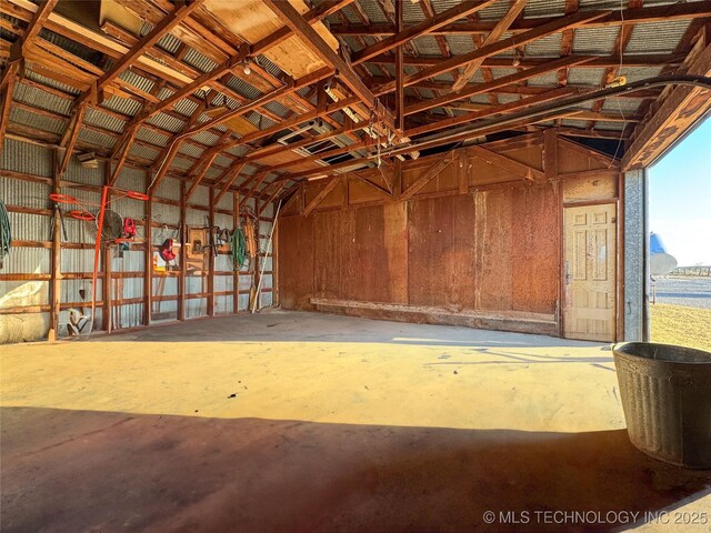 misc room featuring concrete flooring and vaulted ceiling