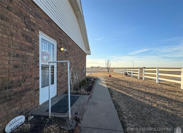 view of side of property with a rural view