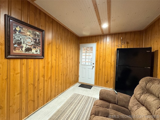 interior space featuring carpet flooring and wooden walls