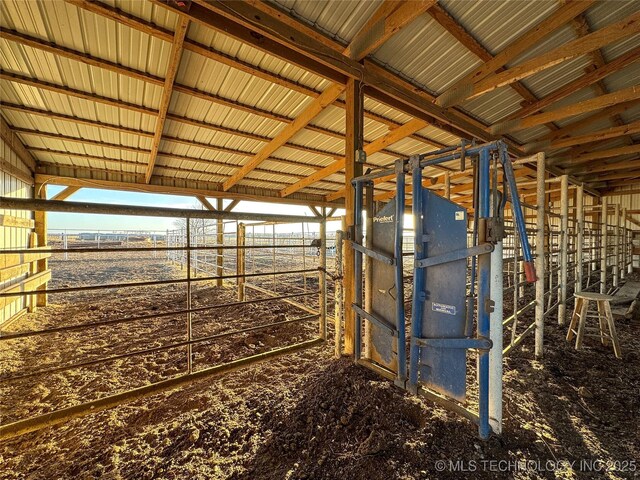 view of horse barn featuring a rural view