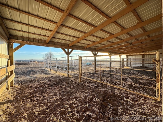 view of horse barn with a rural view