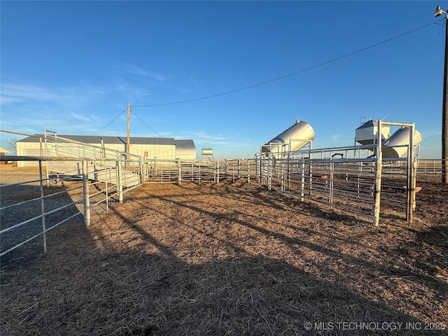 view of yard with an outdoor structure and a rural view