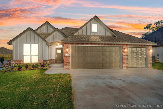 view of front of property featuring a garage and a yard